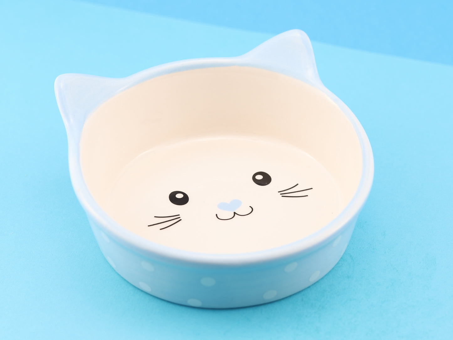 Ceramic cat face bowl, light blue with white polka dots and a cute cat face in the centre of the bowl