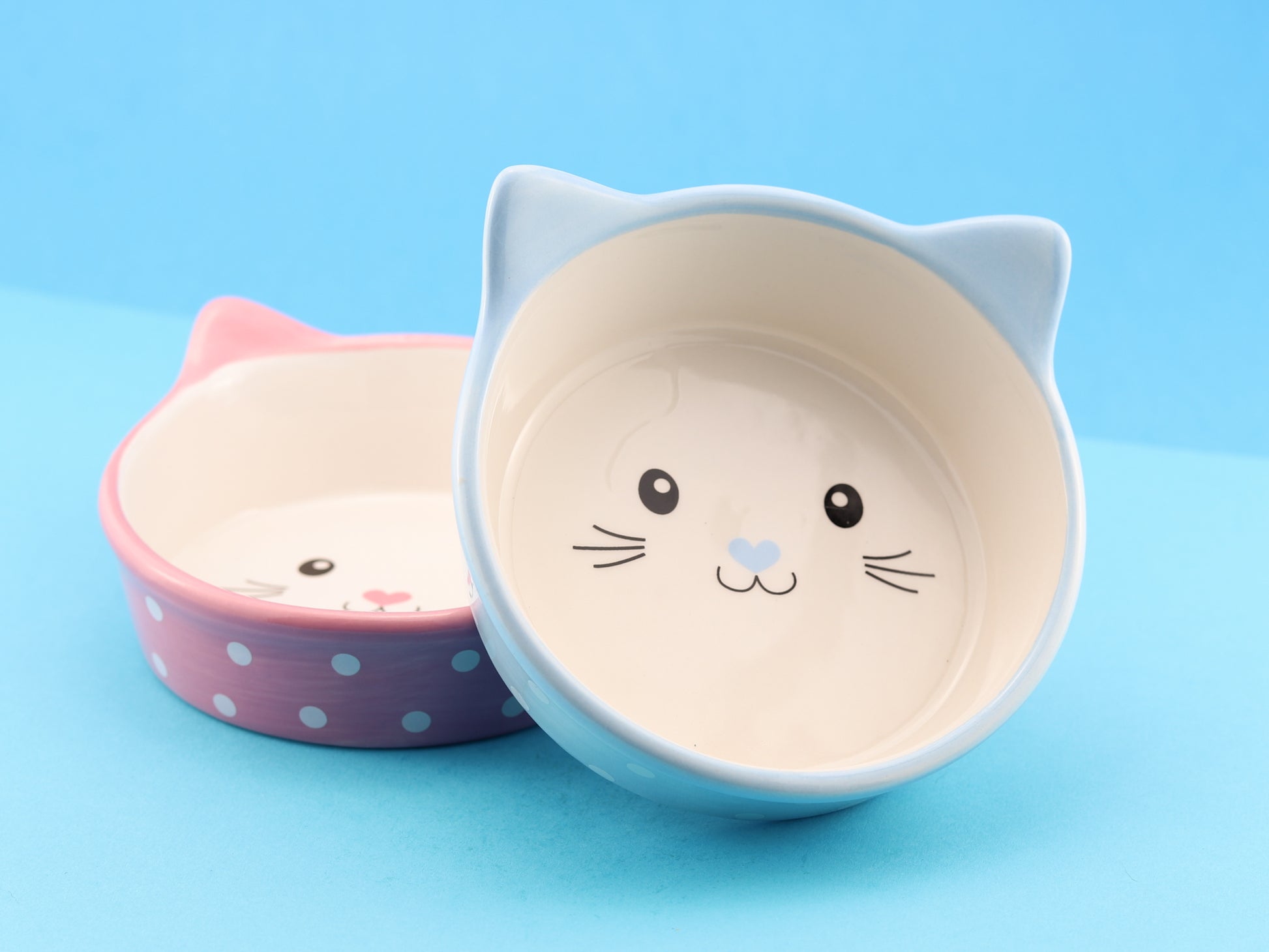 Ceramic cat face bowls in two colours. Pink & blue, with white polka dots and a cute cat face in the centre of the bowl